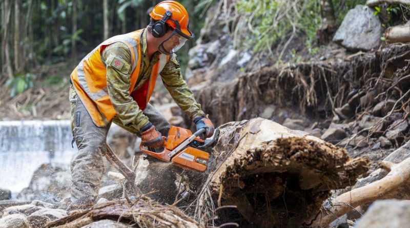 Army engineer Lance Corporal Jack Dalrymple assists Lismore Shire Council to clear debris from Mulgum Creek Weir in Nimbin, New South Wales, as part of Operation Flood Assist 2022. Story by Captain Catalina Martinez Pinto. Photo by Corporal Dustin Anderson.