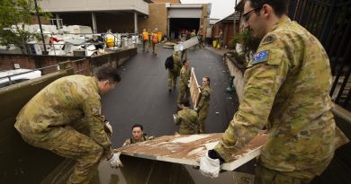 Army soldiers Sapper Callan Stuart, left, and Sapper Ben Lowe, right, load flood-damaged furniture and equipment from Lismore police station in northern NSW onto a truck. Story by Captain Annie Richardson. Photo by Warrant Officer Class Two Max Bree.