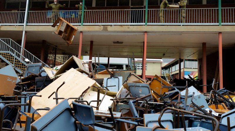 Australian Army soldiers from 1st Armoured Regiment remove flood-damaged equipment and furniture during a clean up of Richmond River High School in Lismore, New South Wales. Story by Captain Annie Richardson. Photo by Warrant Officer Class Two Max Bree.