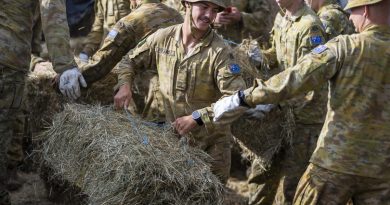 Private Patrick Hyland, centre, from 5th Battalion, Royal Australian Regiment, delivers feed to a farmer near Casino, New South Wales, as part of Operation Flood Assist 2022. Story by Captain Catalina Martinez-Pinto. Photo by Corporal Dustin Anderson.