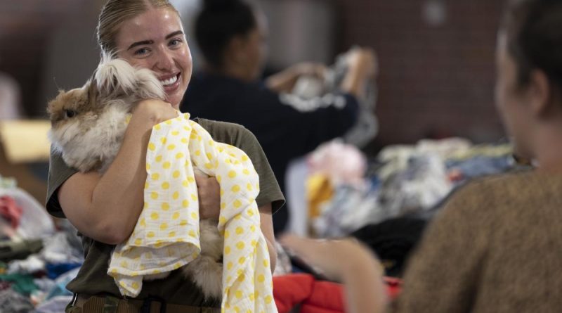 Corporal Rebecca Barry embraces a Casino local while organising donations at the local racecourse and showgrounds in northern NSW as part of Operation Flood Assist 2022. Story by Captain Annie Richardson. Photo by Corporal Sagi Biderman.