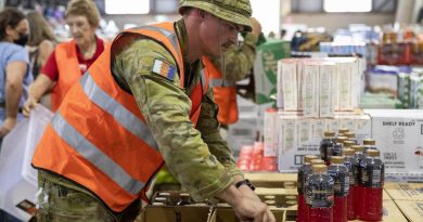 Private Darren Loveday assists volunteers sort essential supplies donated for flood-affected community members at the Lifeline distribution centre in Lismore. Photo by Leading Seaman Kylie Jagiello.