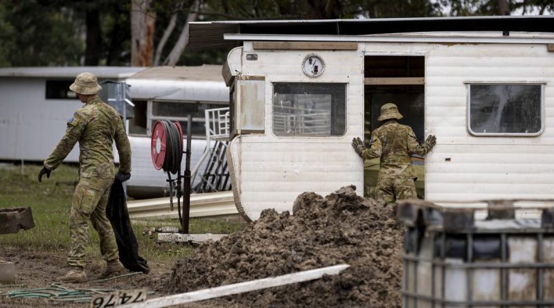 Australian Army soldiers assess and clear debris from Sackville Ski Gardens caravan park in Sydney as part of Operation Flood Assist 2022. Story by Lieutenant Edward Pym. Photo by Corporal Julia Whitwell.