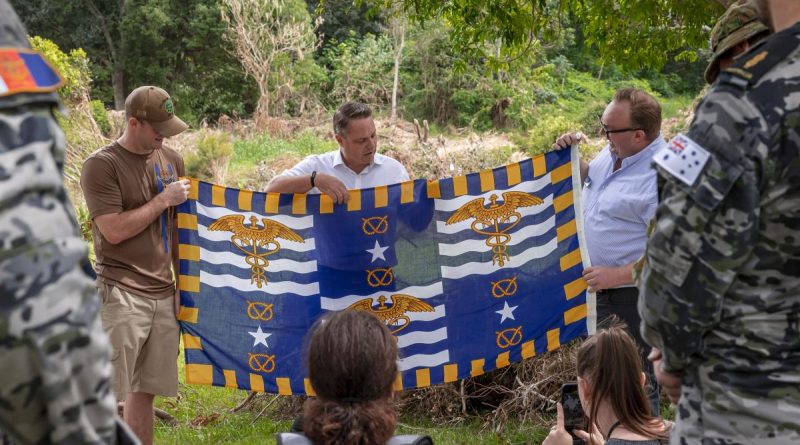 Brisbane Lord Mayor Adrian Schrinner, centre, and Councillor Andrew Wines present Lieutenant Brandon Shellenberger with Brisbane's flag as a token of thanks for the assistance of US personnel during Operation Flood Assist. Story by Flying Officer Robert Hodgson. Photo by Corporal Nicole Dorrett.