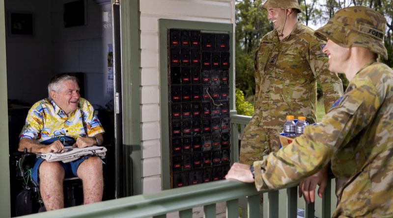 Warrant Officer Class Two Robert Elian and Warrant Officer Class Two Michael Foster (right) with Mr Gary Carr, Empire Vale Post Office manager, after providing flood damage clean-up assistance. Story by Private Jacob Joseph. Photo by Corporal Dustin Anderson.