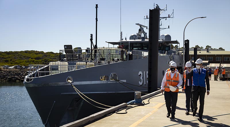 Assistant Minister for Defence Andrew Hastie (right) and Austal senior staff walk down a wharf at the Austal Ships shipyard in Henderson, Western Australia, on launch day for the second Cape-class patrol boat. Photo by Leading Seaman Craig Walton.