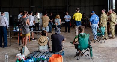 A community meeting to plan flood-relief efforts at the Rotorwings Hanger, Lismore Airport. Photo by Leila Joy.