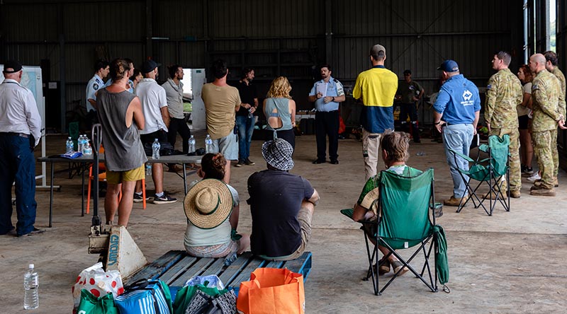 A community meeting to plan flood-relief efforts at the Rotorwings Hanger, Lismore Airport. Photo by Leila Joy.