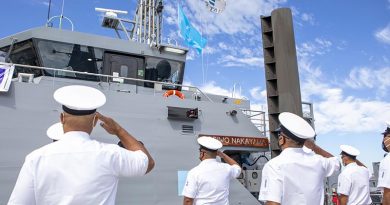 Federated States of Micronesia personnel from the Guardian-class patrol boat FSS Toshiwo Nakayama salute as the Micronesian flag is hoisted on board for the first time during the boat's handover ceremony at Austal ship building facility in Henderson, Perth, Western Australia. Photo by Leading Seaman Ernesto Sanchez.