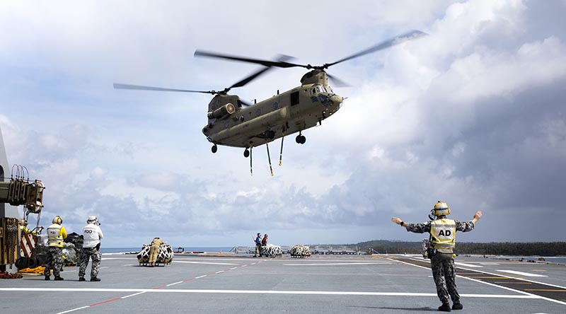 An Australian Army CH-47F Chinook helicopter conducts a vertical replenishment with HMAS Canberra to deliver humanitarian and disaster relief stores to Nomuka Island, Tonga, during Operation Tonga Assist 2022. Photo by Leading Seaman Danial Goodman.