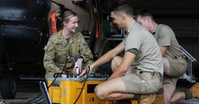 Captain Elise McKenzie, from 5th Aviation Regiment, talks to soldiers conducting maintenance on an MRH-90 Taipan at RAAF Base Townsville. Story by Captain Carolyn Barnett. Photo by Corporal Lisa Sherman.