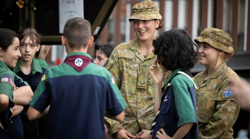 Lance Corporal Madison Parrello (centre) and Private Genna Price (right) from 7th Battalion, Royal Australian Regiment, talk to scouts in Lismore, New South Wales, during Operation Flood Assist 2022. Story by Flight Lieutenant Dee Irwin. Photo by Corporal Jonathan Goedhart.