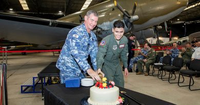 Group Captain Iain Carty, CSM, and United States Air Force aviator Airman First Class Alejandro Duarte (right) from 22nd Airlift Squadron cut the cake during 80th anniversary of the formation of 22nd Airlift Squadron celebrations at RAAF Base Amberley Aviation Heritage Centre. Story by Flight Lieutenant Tanya Carter. Photo by Leading Aircraftwomen Emma Schwenke.
