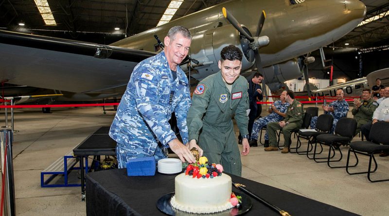 Group Captain Iain Carty, CSM, and United States Air Force aviator Airman First Class Alejandro Duarte (right) from 22nd Airlift Squadron cut the cake during 80th anniversary of the formation of 22nd Airlift Squadron celebrations at RAAF Base Amberley Aviation Heritage Centre. Story by Flight Lieutenant Tanya Carter. Photo by Leading Aircraftwomen Emma Schwenke.