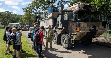 An Australian Army soldier deployed on Operation Flood Assist 2022 prepares to show Rivers Secondary College students over a Rheinmetall MAN M40 truck during a visit to the school in Lismore, New South Wales. Story and photo by Leading Seaman Jarrod Mulvihill.