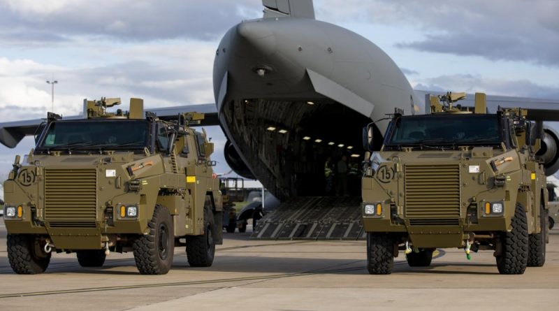 Two Bushmaster protected mobility vehicles bound for Ukraine wait to be loaded onto a C-17A Globemaster III aircraft at RAAF Base Amberley. Photo by Leading Aircraftwoman Emma Schwenke.