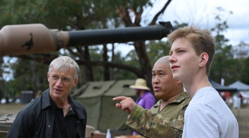 Sergeant Wei Huang, from the School of Armour, discusses the vehicles on display with Henry Rogers and his father, Tom, at the Puckapunyal Military Area community open day. Story by Major Carrie Robards. Photo by Private Kelsey Innes.