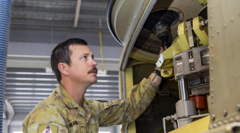 Sergeant Jason Hoare from 5th Aviation Regiment conducts maintenance on a CH-47F Chinook helicopter at RAAF Base Townsville. Photo by Corporal Lisa Sherman.