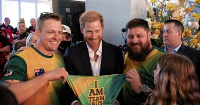 Invictus Games Team Australia competitors Matt Model (left) and Damien Irish (right) gift a pair of Team Australia swimmers to Prince Harry, The Duke of Sussex. Story by Lucy Redford-Hunt. Photo by Flight Sergeant Ricky Fuller.