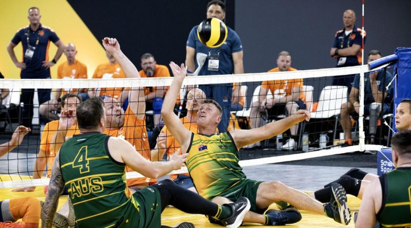 Invictus Games 2020 competitor Mark Armstrong deflects the ball during the sitting volleyball match against Netherlands at Invictus Games Park in The Hague, Netherlands. Story by Tina Langridge. Photo by Flight Sergeant Ricky Fuller.