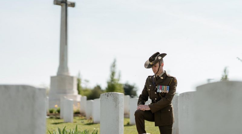 Major Christopher Pitman from Australia's Federation Guard pauses to reflect at the headstone of fallen Australian soldier from the First World War in Villers-Bretonneux Military Cemetery, France. Story by Captain Sarah Kelly. Photo by Corporal John Solomon.