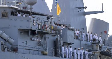 The ship's company of HMAS Arunta line the upper decks as they return to Fleet Base East in Sydney after a three-month regional presence deployment. Story by Lieutenant Gary McHugh and Lieutenant Commander Victor Yee. Photo by Leading Seaman Leo Baumgartner.