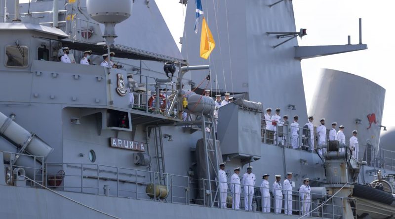 The ship's company of HMAS Arunta line the upper decks as they return to Fleet Base East in Sydney after a three-month regional presence deployment. Story by Lieutenant Gary McHugh and Lieutenant Commander Victor Yee. Photo by Leading Seaman Leo Baumgartner.