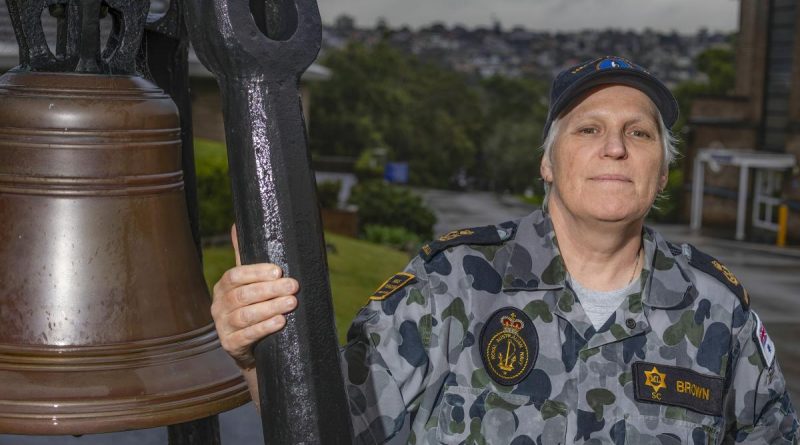 Chief Petty Officer Sharon Brown stands next to the historic HMAS Penguin bell in Sydney. Story by Corporal Veronica O'Hara. Photo by Able Seaman Benjamin Ricketts.