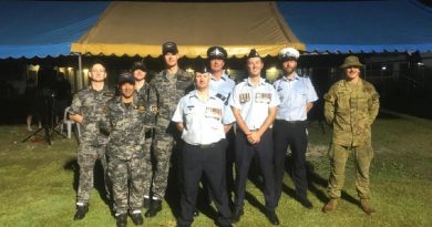 HMAS Glenelg crew members at the Cocos (Keeling) Islands' community Anzac Day dawn service, with Royal Australian Air Force and Australian Federal Police personnel. Story by Lieutenant Commander Alexander Finnis.