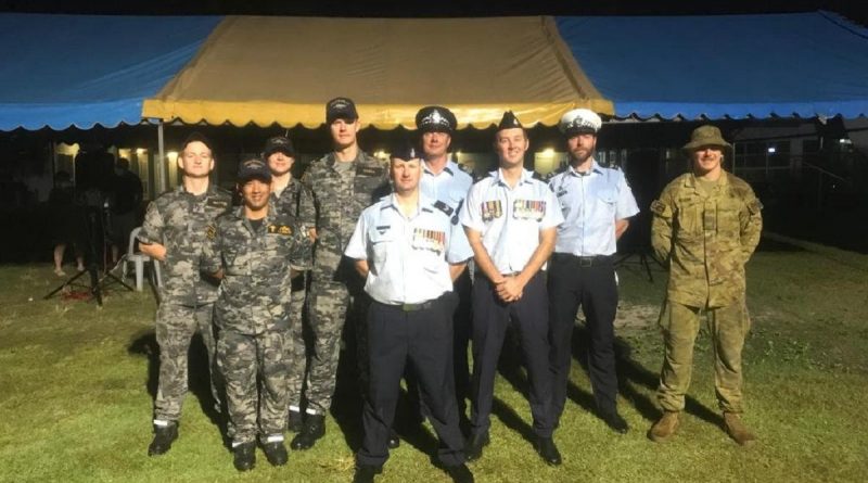 HMAS Glenelg crew members at the Cocos (Keeling) Islands' community Anzac Day dawn service, with Royal Australian Air Force and Australian Federal Police personnel. Story by Lieutenant Commander Alexander Finnis.