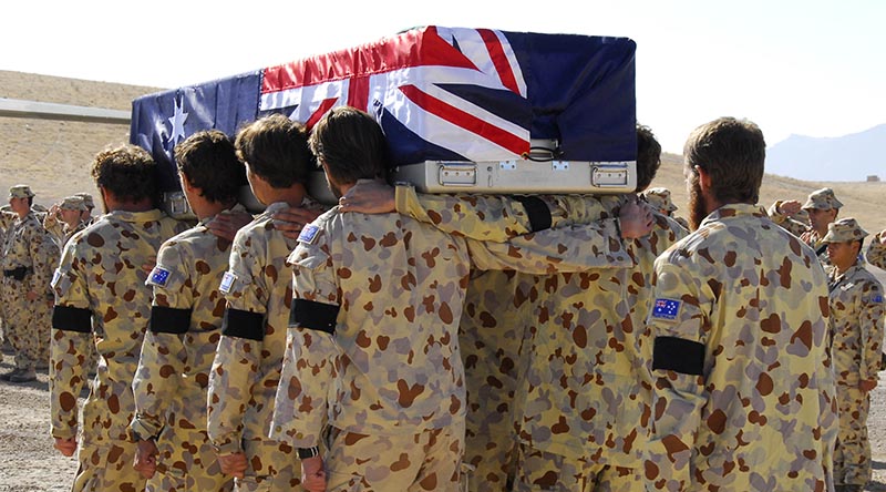 Australian soldiers from the Special Operations Task Group and Reconstruction Task Force farewell fallen comrade Private Luke Worsley during a ramp ceremony at their base in Uruzgan Province, southern Afghanistan on 27 November 2007. Photo by Captain Al Green.