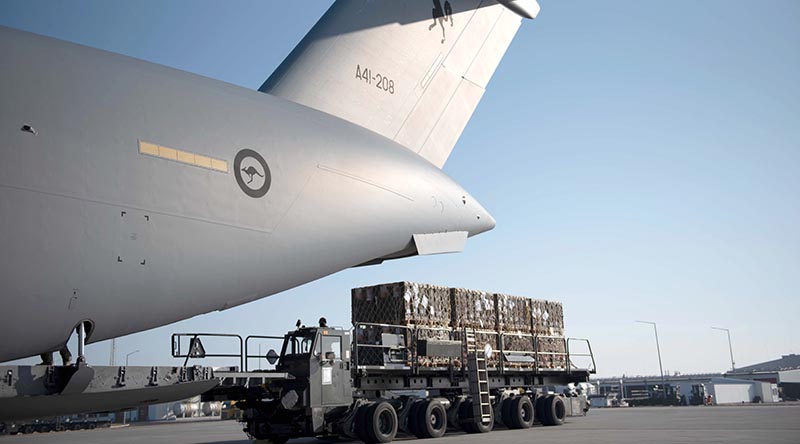 Pallets of Australian-supplied defensive military assistance supplies are off-loaded from an RAAF C-17A Globemaster III strategic airlift aircraft at a base 'somewhere in Europe' for on-forwarding to Ukraine. US Air Force photo.