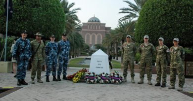 Australian Defence Force and New Zealand Defence Force personnel stand by the cenotaph after the Anzac Day commemorations in Abu Dhabi, United Arab Emirates. Story and photo by Captain Edward Pym.