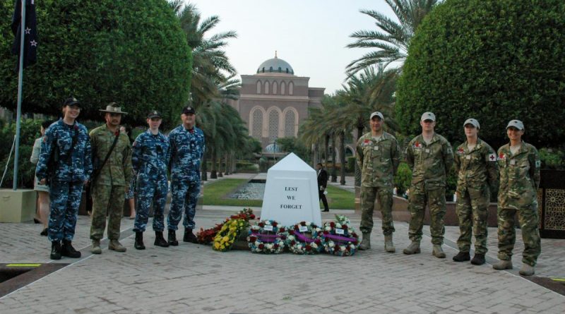 Australian Defence Force and New Zealand Defence Force personnel stand by the cenotaph after the Anzac Day commemorations in Abu Dhabi, United Arab Emirates. Story and photo by Captain Edward Pym.
