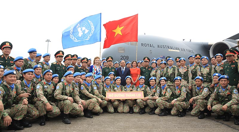 President of Vietnam Nguyễn Xuân Phúc (centre), and Australian Ambassador to Vietnam Robyn Mudie (centre right), farewell Vietnamese peacekeepers in Hanoi, deploying to the United Nations mission in South Sudan on a Royal Australian Air Force C-17A Globemaster III. Photo supplied. Left to right: Ms Caitlin Wiesen-Antin (white scarf), United Nations Acting Resident Coordinator for Vietnam; Senior General Phan Văn Giang, Vietnam’s Minister for National Defence; President Nguyễn Xuân Phúc; Ms Mudie.
