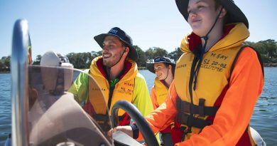 Australian Navy Cadet instructor Lieutenant AJ Hughes instructs Cadet Seaman Charlee Bell with driving a Rigid-Hulled Inflatable Boat. Photo by Sam Thies.