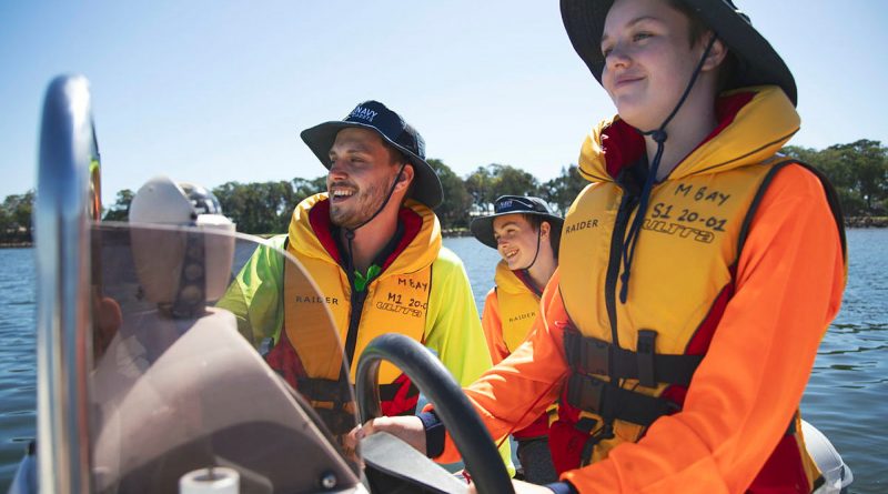 Australian Navy Cadet instructor Lieutenant AJ Hughes instructs Cadet Seaman Charlee Bell with driving a Rigid-Hulled Inflatable Boat. Photo by Sam Thies.