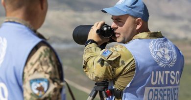 Captain John Whiteley, right, confirms the presence of military equipment with Finnish colleague Captain Pasi Nukarinen during a routine patrol in the Golan Heights. Story and photo by Petty Officer Lee-Anne Cooper.