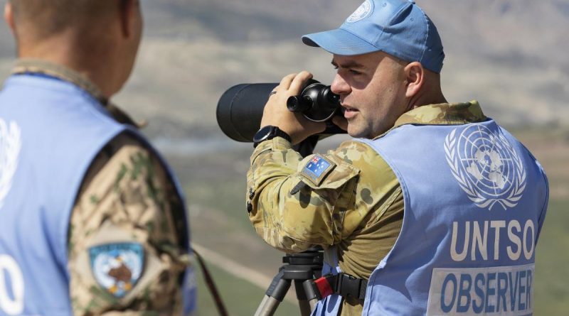 Captain John Whiteley, right, confirms the presence of military equipment with Finnish colleague Captain Pasi Nukarinen during a routine patrol in the Golan Heights. Story and photo by Petty Officer Lee-Anne Cooper.