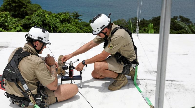 Corporal Blake Smythe and Lance Corporal Carl Tangredi, from 1st Signal Regiment, conduct safety checks before conducting maintenance on the communication equipment at Lombrum Naval Base on Manus Island. Story by Captain Jessica O’Reilly. Photo by Lance Corporal George Corchis.