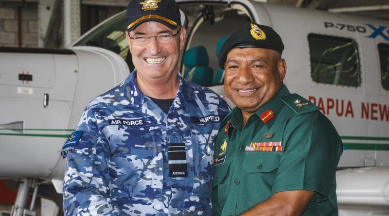 Chief of Royal Australian Air Force, Air Marshal Mel Hupfeld and Major General Mark Goina (right), Chief of Papua New Guinea Defence Force, shake hands after signing an aviation safety memorandum of understanding at Air Transport Wing in Port Moresby. Story by John Noble.