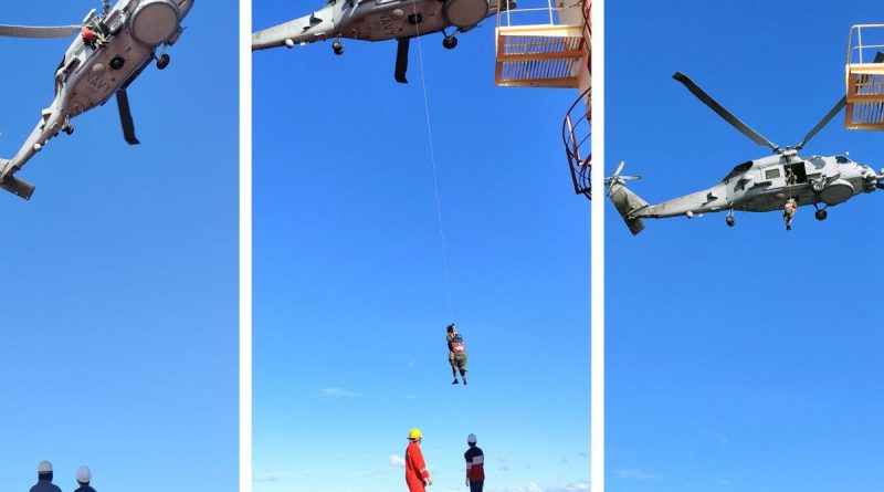 HMAS Parramatta’s MH-60R Seahawk helicopter winches the patient from the deck of Sea Angel bulk carrier. Photo courtesy of AMSA