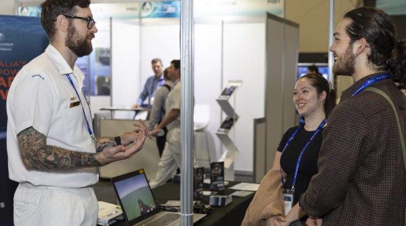 Petty Officer Electronics Technician Submarines Michael Budden works at the Defence Force Recruiting stand during the Royal Australian Navy Sea Power Conference as part of Indo Pacific 2022 held in Sydney.