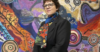 Assistant Director Defence Indigenous Procurement Policy Mrs Tanya Martens from the Capability Acquisition & Sustainment Group stands in front of an Indigenous artwork at Russel Offices in Canberra. Story by Warrant Officer Class Two Max Bree. Photo by Sergeant Matthew Bickerton.