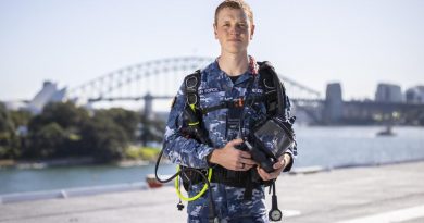 Flight Lieutenant Kristian Henderson with his dive gear on board HMAS Adelaide's alongside Garden Island. Story by Lieutenant Brendan Trembath. Photo by Leading Seaman Matthew Lyall.