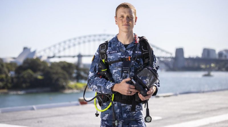 Flight Lieutenant Kristian Henderson with his dive gear on board HMAS Adelaide's alongside Garden Island. Story by Lieutenant Brendan Trembath. Photo by Leading Seaman Matthew Lyall.