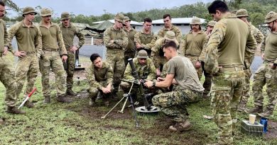 Australian Army soldiers, from 6th Battalion, Royal Australian Regiment, watch a demonstration of the M224 60mm mortar by United States Marine Corps personnel at Shoalwater Bay training area, near Rockhampton.
