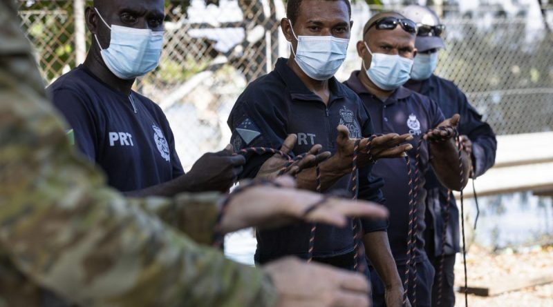 Solomon Islands Police Force officers practise their knot tying skills as part of practical maritime safety training with the Australian Defence Force in the use and maintenance of aluminium long boats in Honiara. Photo by Corporal Julia Whitwell.