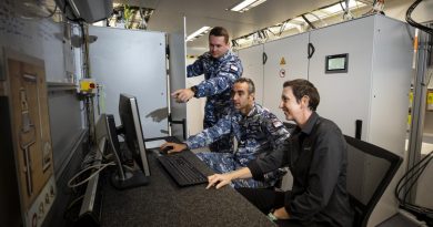 RAAF technicians Corporal Nima Nikfarjam, centre, and Leading Aircraftman Matthew Crowe, left, talk with Hensoldt Australia instructor Prue Bowley about the ASR-NG radar system. Story by By Flight Lieutenant Claire Burnet. Photo by Leading Aircraftwoman Emma Schwenke.