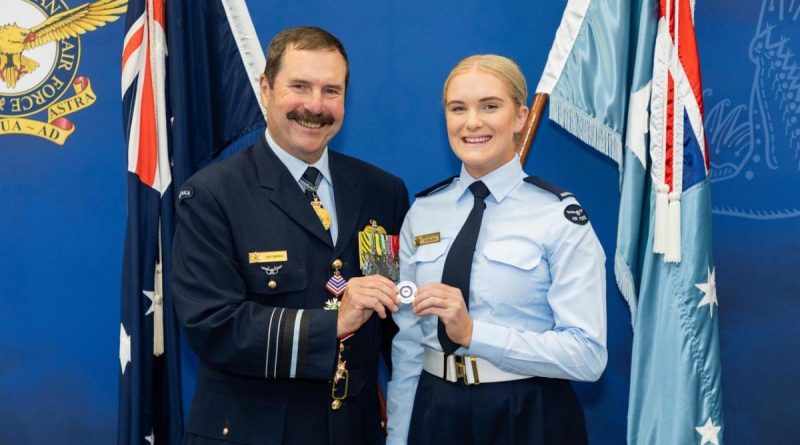 Former chief of Air Force, Air Marshal (retd) Gavin ‘Leo’ Davies, with Aircraftwoman Brooklynn Dowling after her graduation from recruit training, holding the challenge coin the former chief had given to her five years ago. Story by Squadron Leader Matthew Kelly. Photo from Cut Above Productions.